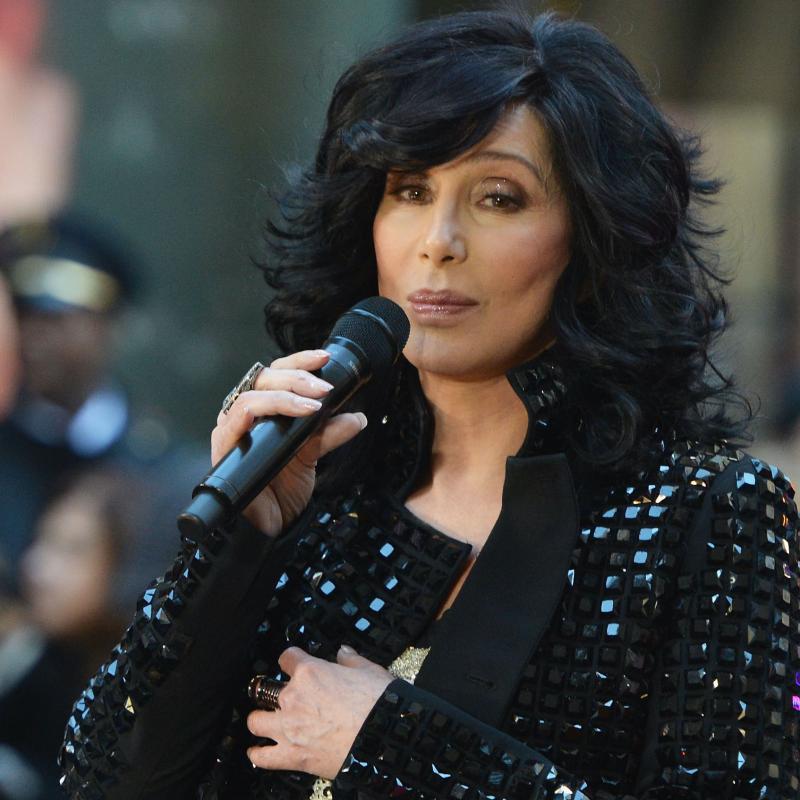 Cher sings into a microphone