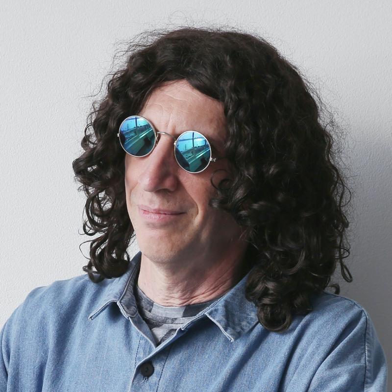 Howard Stern wearing reflective sunglasses