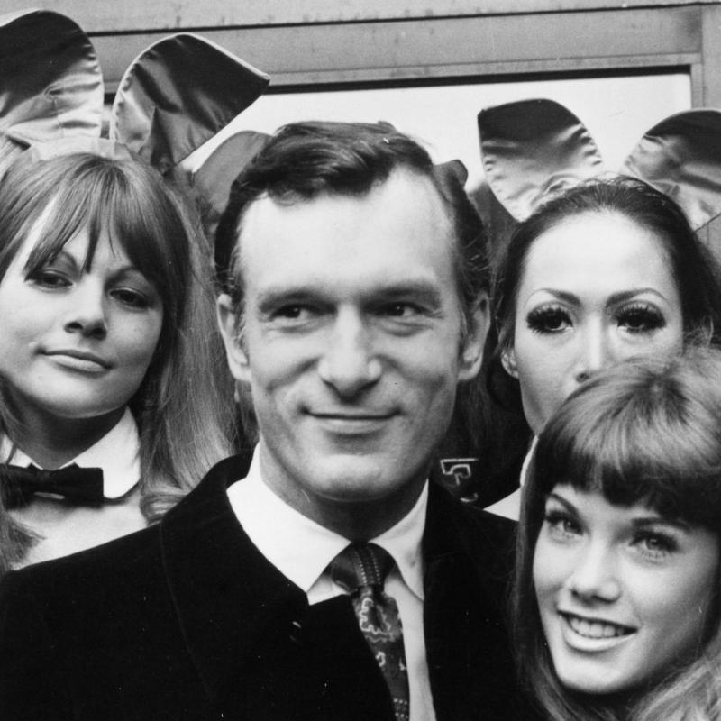 Playboy publisher Hugh Hefner in the late 1960s surrounded by women wearing bunny ears.