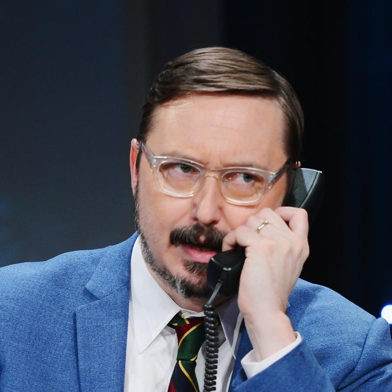 Comedian John Hodgman talks on the telephone