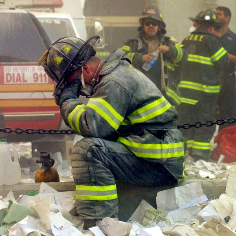 Firefighters work amid the wreckage of the World Trade Center on September 11, 2001