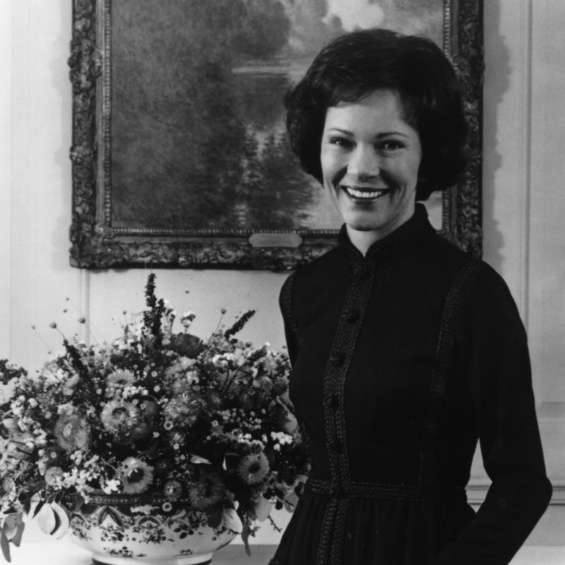 Rosalynn Carter standing in front of a painting